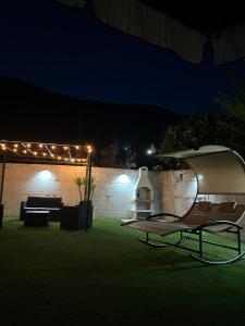 a patio at night with a chair and lights at Cottage Cilento B&B in Trentinara