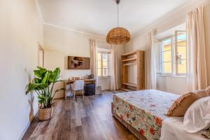 a bedroom with a bed and a desk at I Due Mondi Rooms in Portoferraio