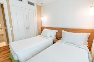 Cama ou camas em um quarto em Intercity The Universe Paulista