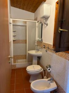 a bathroom with a toilet and a sink and a shower at Villa Incanto B&B in Caprioli