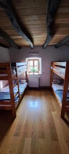 a room with three bunk beds and a window at Casa mandoia in Igorre