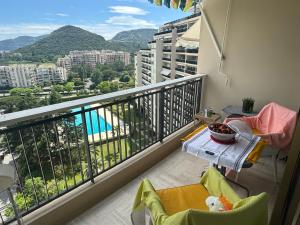 a balcony with a table and a view of a pool at Cozy 2-rooms apartment in yacht port Cannes Marina in Mandelieu-la-Napoule