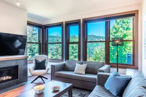 a living room with a couch and a fireplace at Waterfront condo with magnificent view in Lac-Superieur