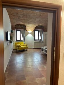 a view of a living room with a yellow couch at Cascina Mabette in Farigliano