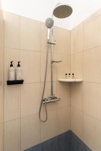 a shower with a shower head in a bathroom at Lagadia Village in Antiparos