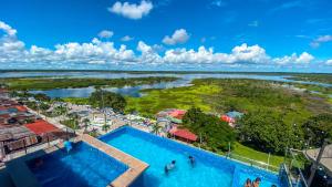 an overhead view of a swimming pool and a river at Hotel de Turistas Iquitos in Iquitos