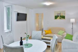 a living room with a table and a couch at Apartment Bela in Senj