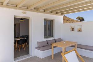 a living room with a couch and a table at Lagadia Village in Antiparos