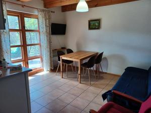a living room with a wooden table and chairs at Domki przy lesie in Werblinia