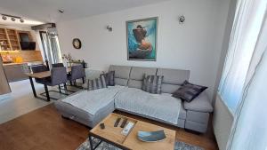 a living room with a couch and a table at Apartman NAR Murter in Murter