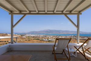 a view from the balcony of a house with two chairs at Lagadia Village in Antiparos