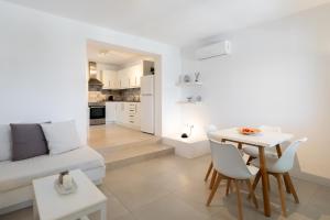 a living room with a couch and a table at Lagadia Village in Antiparos