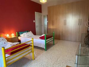 a room with two beds and two benches in it at Pamper Rooms in Pembroke