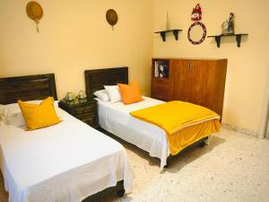 two beds sitting next to each other in a bedroom at Pamper Rooms in Pembroke +10 photos