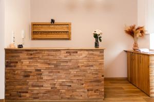 a brick wall in a room with a vase of flowers at Pension Märkl Augsburg in Augsburg