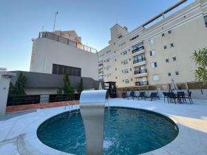 a swimming pool on the roof of a building at Flat no Gonzaga - Santos in Santos