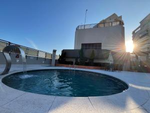 a pool of water in front of a building at Flat no Gonzaga - Santos in Santos