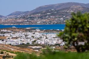 a view of a town with the water and mountains at Lagadia Village in Antiparos