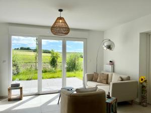 a living room with a couch and a sliding glass door at GC - Idem in Wissant
