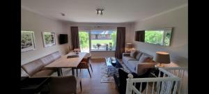 a living room with a couch and a table at Kliffblick am Watt in Wenningstedt