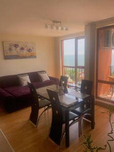 a living room with a table and a couch at Sea view apartment in Sveti Vlas in Elenite