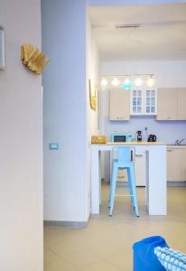 a kitchen with a blue island in a room at Umbre de Muri - Riomaggiore - 5 terre in Riomaggiore