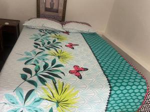 a bed with butterflies on it in a bedroom at villa mariposa in Santo Domingo