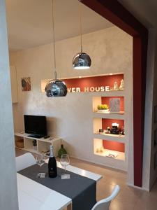 a dining room with a table and two wine glasses at The River House in Boiano