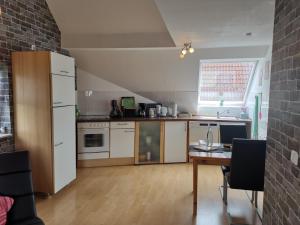 a kitchen with a table and a refrigerator at Ferienwohnung Grünberger Land in Grünberg
