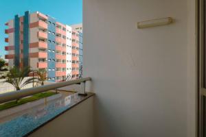 a balcony with a view of a building at Apto Piscina Academia Ar Cond CID108C in Maringá
