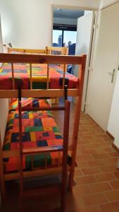 a bedroom with two bunk beds and a window at DOMAINE et MER in Six-Fours-les-Plages