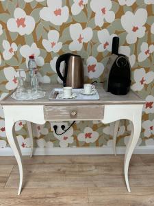 a table with a tea kettle and cups on it at Domaine de la Gémolière in Gémozac