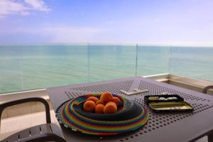 a table with a bowl of oranges on top of it at Villa Flora in Sozopol