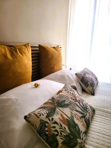 a bed with two pillows on top of it at La Dimora dell'Arte in Bari