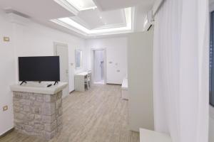 a living room with a flat screen tv on a wall at Hotel RR in Herceg-Novi
