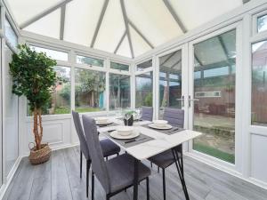 a dining room with a table and chairs and windows at B92-HS2-NEC-BHX-Contractor's-guests welcome in Sheldon