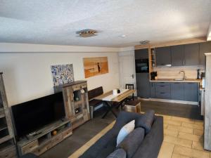 a living room with a couch and a kitchen at Binzgen in Luttingen