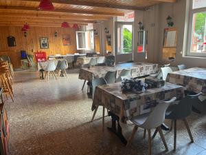 a dining room with tables and chairs and tablesktop at Tifani Szálló in Balatonlelle