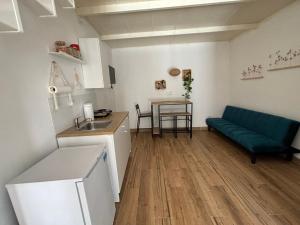 a kitchen and living room with a couch and a table at PortaLecce B&B in Brindisi +94 photos