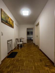 an empty hallway with a table and chairs in a room at Budget Studio - 2 Einzelbetten - Parkplatz in Dornbirn
