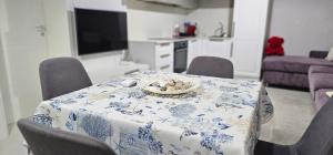 a dining room table with a blue and white table cloth at Oasis Apartment in Golem