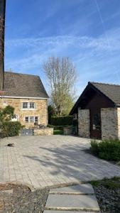 a brick house with a driveway in front of it at Chambre à TROOZ dans magnifique fermette - très calme, jacuzzi - 40 minutes de Spa - Francorchamps in Trooz