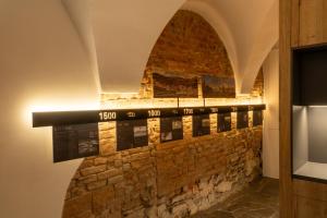 a stone wall with a display in a room at White Wolf Boutique Apartments in Olomouc +24 photos