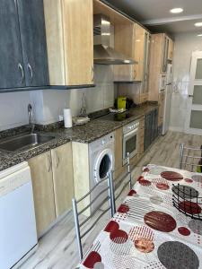 A kitchen or kitchenette at Apartamentos El Conde