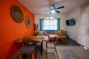 a living room with a table and a couch at Villa Cascada By Vacation Pura Vida in Esterillos Este