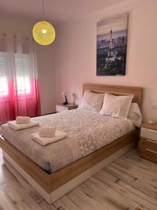A bed or beds in a room at Apartamentos El Conde