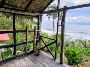 a room with a view of the ocean at Lodge El Amargal - Reserva Natural, Ecoturismo & Surf in Nuquí