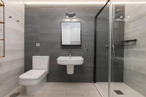 a bathroom with a toilet and a sink and a shower at Livemálaga Alta Suite & Parking in Málaga +12 photos