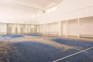 an empty basketball court in an empty building at Livemálaga Alta Suite & Parking in Málaga