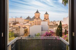 a view from a window of a city with a church at Livemálaga Alta Suite & Parking in Málaga